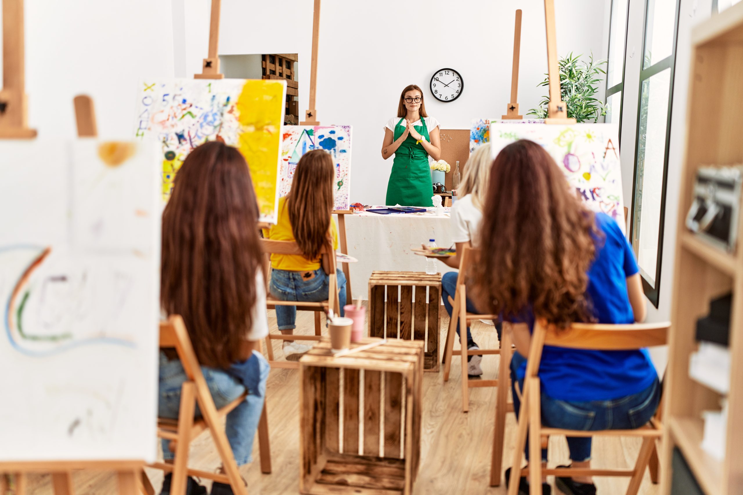 Group of young artist girls having draw lesson at art studio.