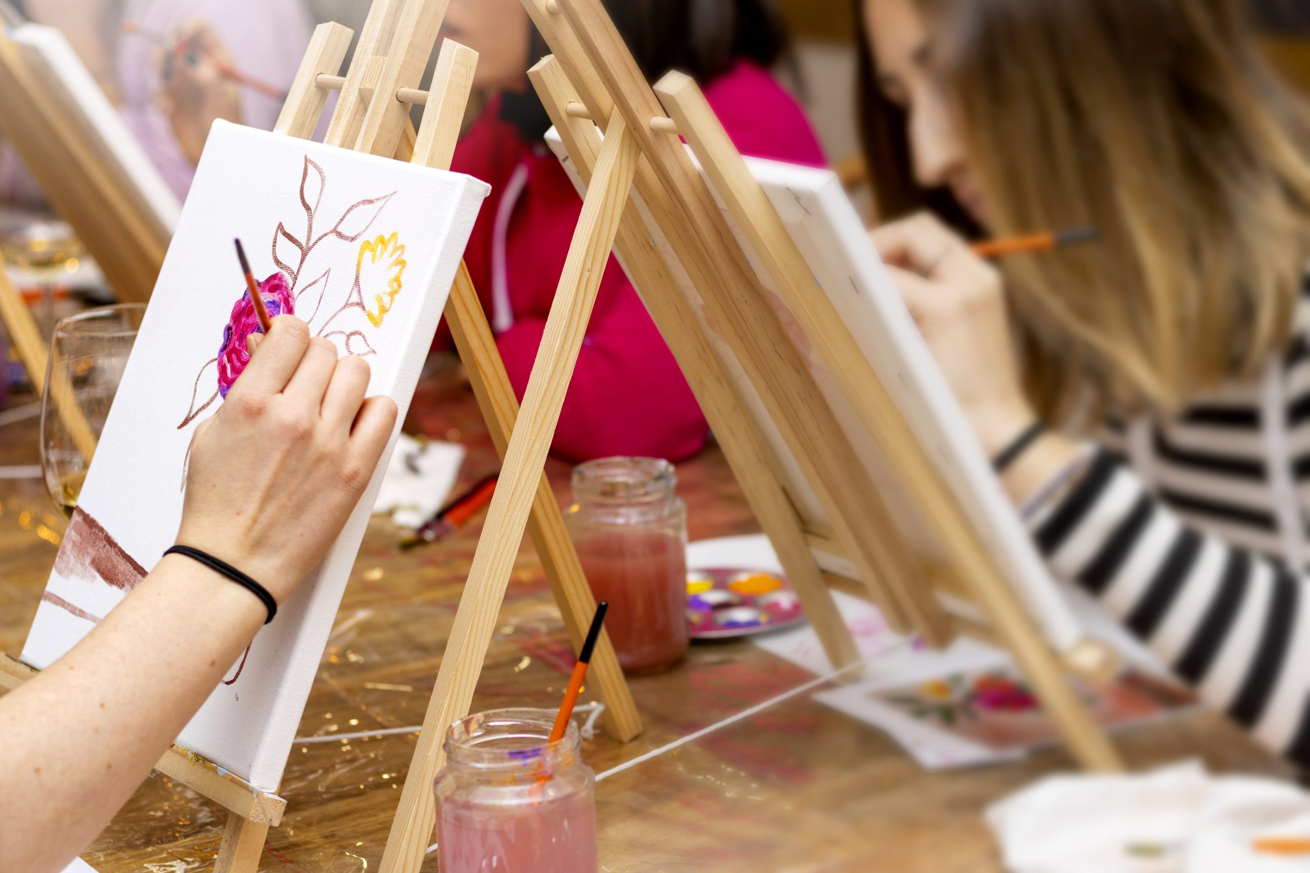 Painting Workshop. Group lesson in drawing. Girls learn to draw in the classroom.
